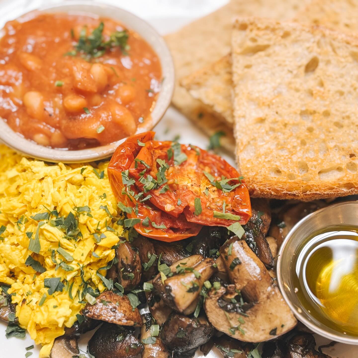 Tucked into a little nook at the end of the road, The Star Anise was buzzing every single morning we visited during our 10-day UK trip, and for good reason. This place serves what I consider the perfect breakfast, something surprisingly hard to find in a casual setting with well-executed vegan options. Plenty of places had vegan plates, but few did them this well.The space has an open, airy artist vibes with posters covering a corkboard advertising local events, and the crowd is a mix from young hipsters to wise locals. The simple menu is perfectly executed, and the staff are genuinely lovely.Each morning I ordered the breakfast plate, toast, mushrooms, beans, and grated tofu scramble (a new technique for me!) with either vegan butter or olive oil, plus their excellent in-house hot sauce on the side, alongside an oat latte. They also offer vegan croissants, energy balls, and lunch options worth exploring. The locals are truly lucky to have this gem!📍Stroud, UK🍄 not fully vegan but fully vegetarian☀️Outdoor seating available